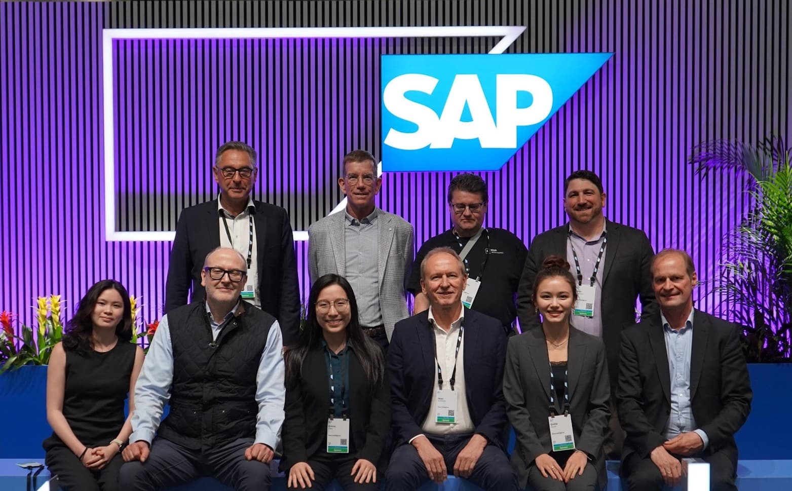 The Nova team posing in front of the SAP logo at SAP Sapphire